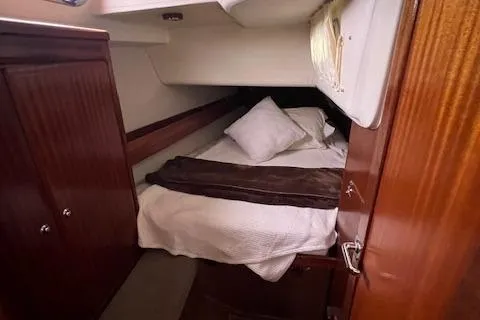 Slide: The Image of Cozy cabin interior of 2000 Bavaria 42 Cruiser yacht with bed and wooden furnishings. - 33