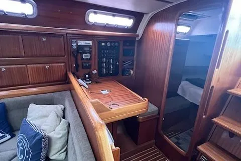 Slide: The Image of Interior of 2000 Bavaria 42 Cruiser yacht with navigation station and cozy seating area. - 35
