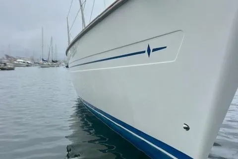 Slide: The Image of Bavaria 42 Cruiser 2000 sailboat docked in a marina, side view. - 6