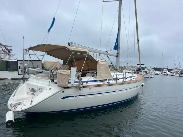 Slide: The Image of 2000 Bavaria 42 Cruiser sailboat docked in a marina, overcast sky. - 2