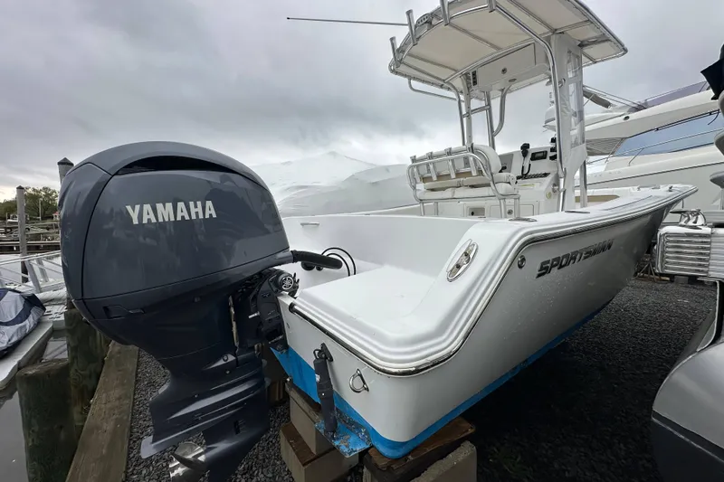 Slide: The Image of 2014 Sportsman Heritage 211 Center Console boat with Yamaha outboard motor at dock. - 1