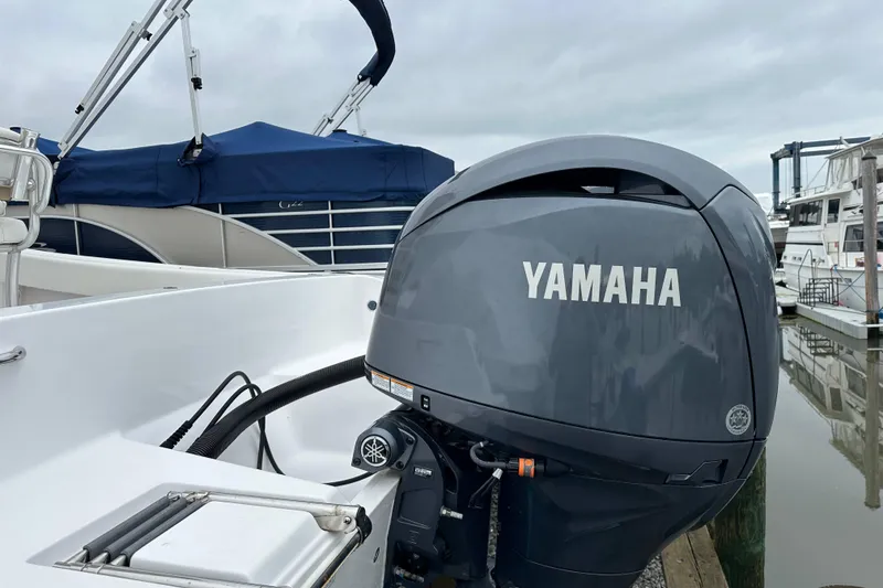 Slide: The Image of 2014 Sportsman Heritage 211 Center Console with Yamaha outboard motor at marina. - 10