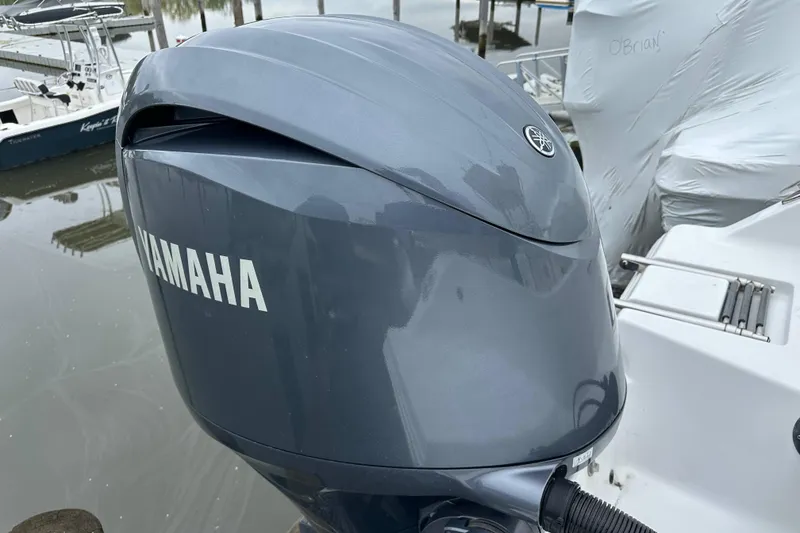 Slide: The Image of Yamaha outboard motor on a 2014 Sportsman Heritage 211 Center Console boat. - 12