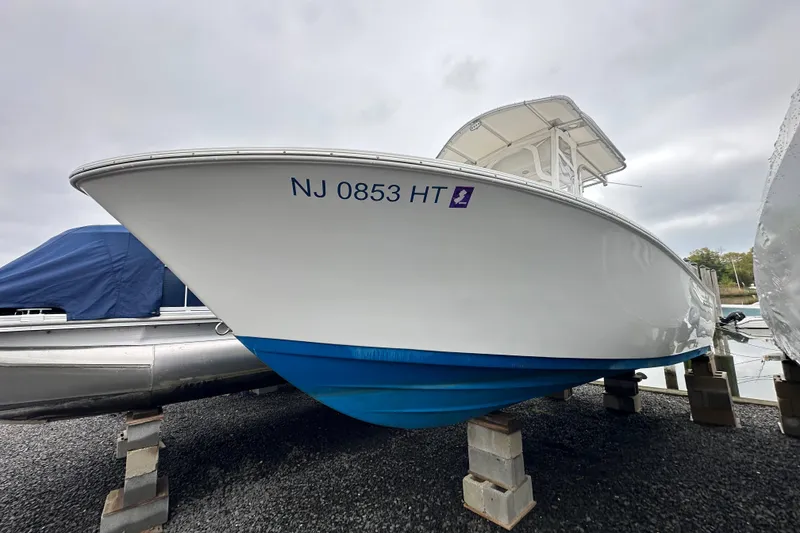 Slide: The Image of 2014 Sportsman Heritage 211 Center Console boat on blocks, registration NJ 0853 HT. - 13