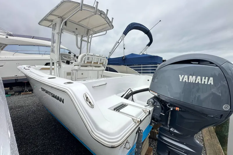 Slide: The Image of 2014 Sportsman Heritage 211 Center Console boat with Yamaha engine at dock. - 14