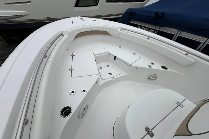 Slide: The Image of 2014 Sportsman Heritage 211 Center Console boat interior with seating and storage compartments. - 15
