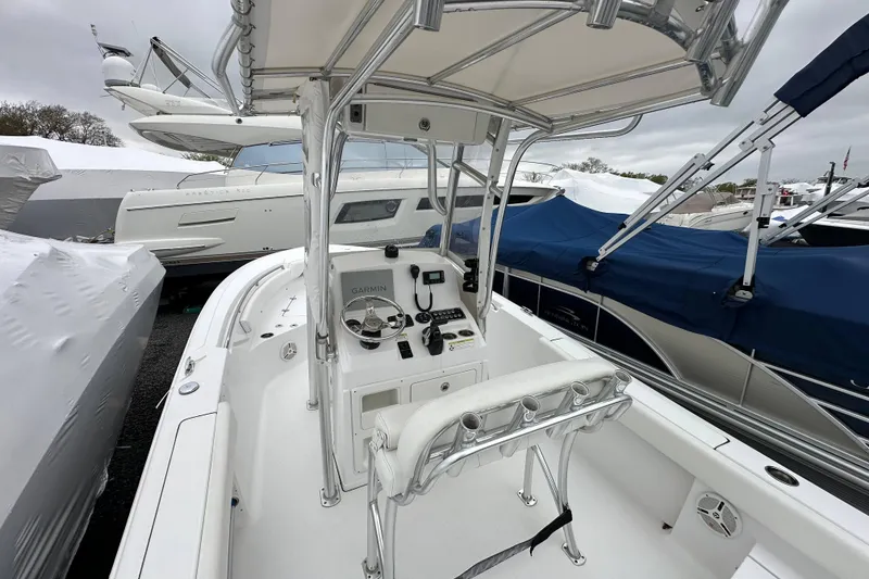 Slide: The Image of 2014 Sportsman Heritage 211 Center Console boat with covered helm and modern controls. - 25