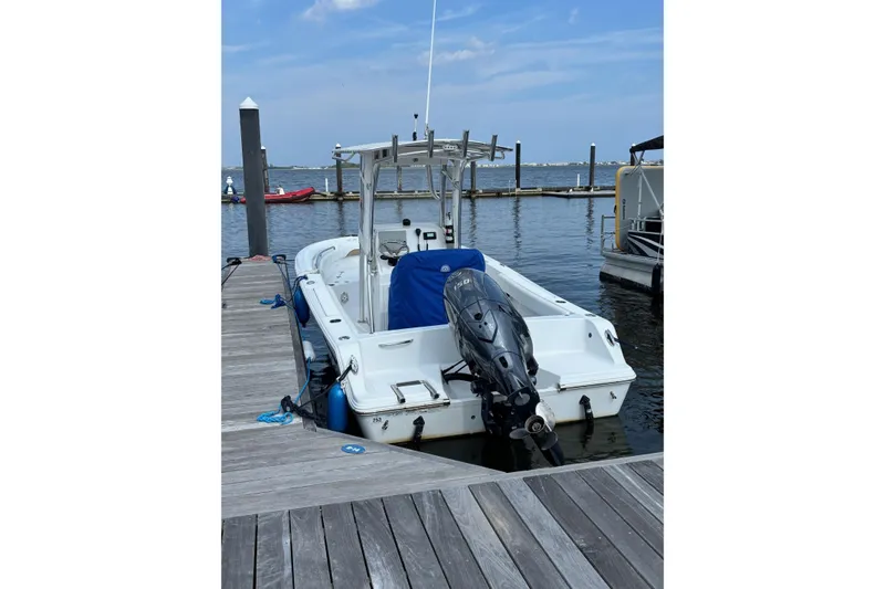Slide: The Image of 2014 Sportsman Heritage 211 Center Console boat docked at marina. - 4