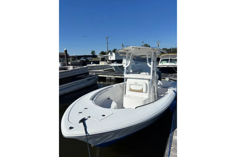 Slide: The Image of 2014 Sportsman Heritage 211 Center Console boat docked under clear blue sky. - 8