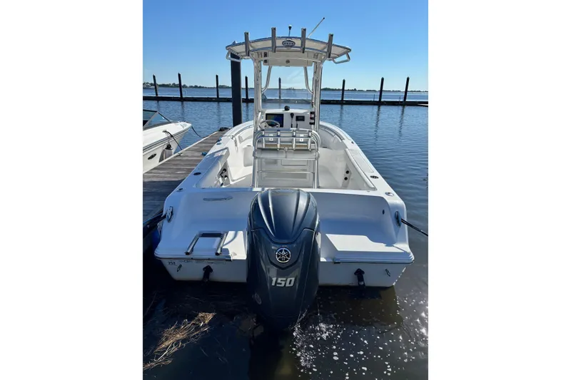 Slide: The Image of 2014 Sportsman Heritage 211 Center Console boat docked with outboard motor. - 9