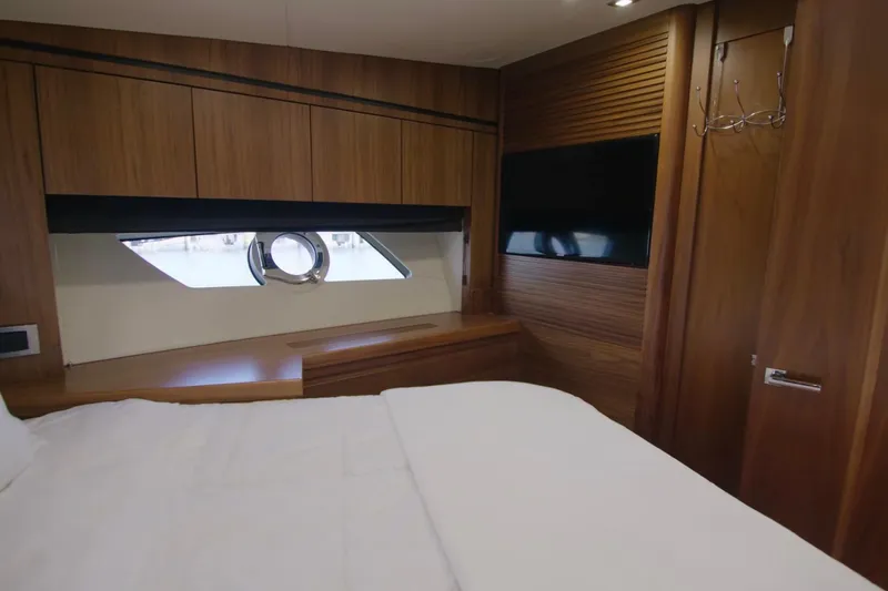 Slide: The Image of Luxurious cabin interior of 2014 Sunseeker Manhattan 55 yacht with wood paneling and porthole window. - 10