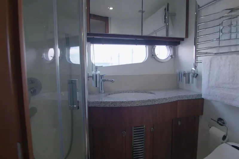 Slide: The Image of Luxurious bathroom in 2014 Sunseeker Manhattan 55 yacht with modern fixtures and porthole windows. - 12