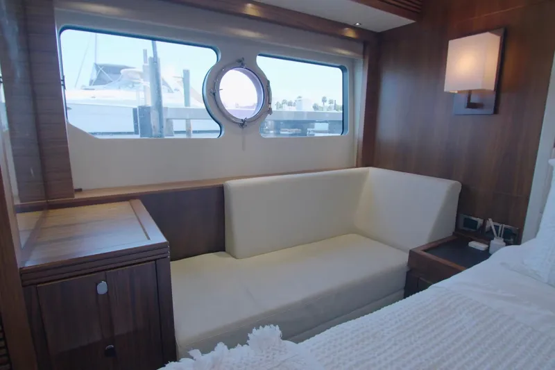 Slide: The Image of Luxurious interior of 2014 Sunseeker Manhattan 55 yacht with elegant seating and porthole view. - 13