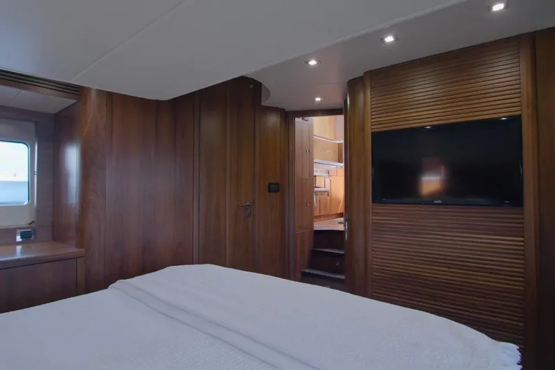 Slide: The Image of Luxurious cabin interior of 2014 Sunseeker Manhattan 55 yacht with wood paneling and TV. - 15