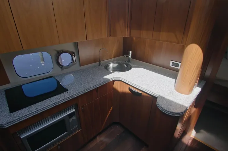 Slide: The Image of Luxurious kitchen interior of 2014 Sunseeker Manhattan 55 yacht with wooden cabinetry. - 18