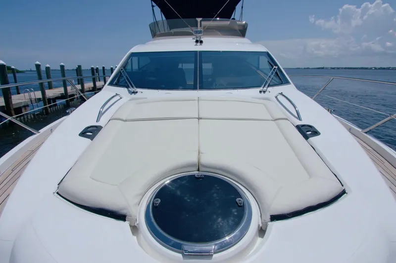 Slide: The Image of 2014 Sunseeker Manhattan 55 yacht with spacious deck and sleek design, docked by the water. - 2