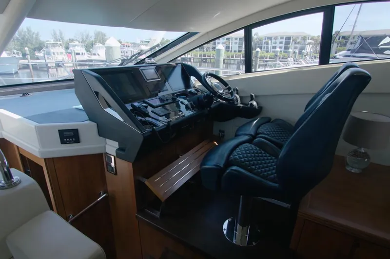 Slide: The Image of Luxurious helm of 2014 Sunseeker Manhattan 55 yacht with modern controls and leather seating. - 20