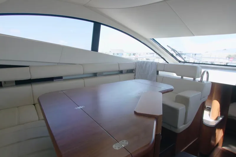 Slide: The Image of Luxurious interior of 2014 Sunseeker Manhattan 55 yacht with elegant seating and wooden table. - 21