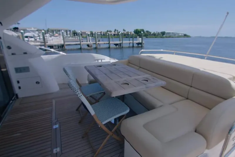 Slide: The Image of Luxurious seating area on 2014 Sunseeker Manhattan 55 yacht, docked by the water. - 22