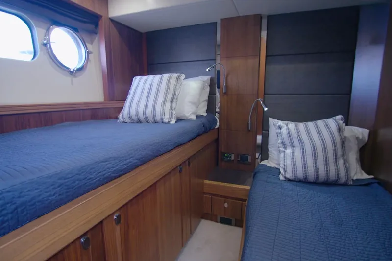 Slide: The Image of Luxurious twin cabin in 2014 Sunseeker Manhattan 55 yacht with blue bedding. - 8