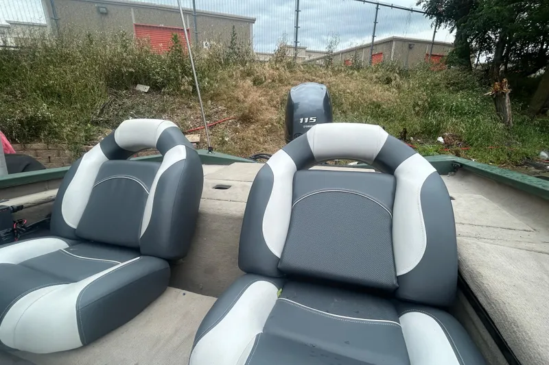 Slide: The Image of 2021 Xpress X18PFC boat interior with dual gray and white seats, Yamaha 115 engine. - 10