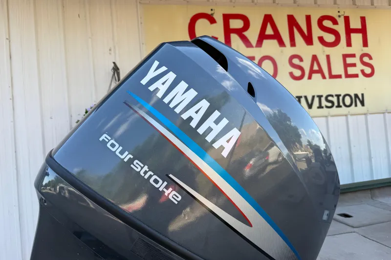 Slide: The Image of Yamaha four-stroke engine at Cransh Auto Sales, displayed on a 2014 Xpress H18 boat. - 11
