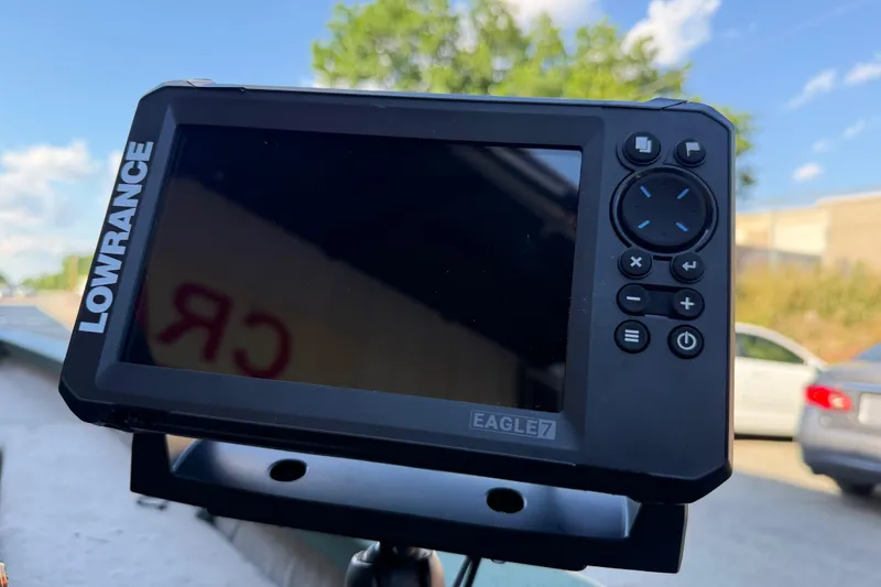 Slide: The Image of Lowrance Eagle 7 fish finder on Xpress H18, 2014 model, outdoors with cars and trees. - 14