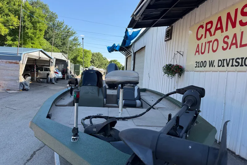 Slide: The Image of 2014 Xpress H18 boat parked outside Crans Auto Sales, near garage area. - 16
