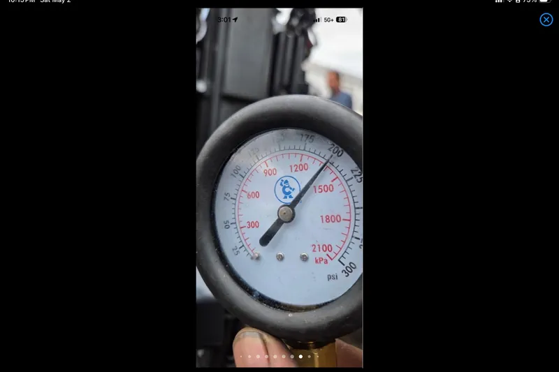 Slide: The Image of Close-up of a pressure gauge displaying kPa and psi readings, Xpress H18, 2014 model. - 21