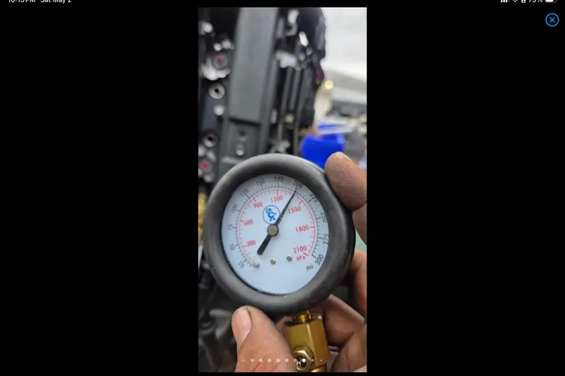Slide: The Image of Close-up of a pressure gauge reading 2100 kPa, held by a hand. Xpress H18, 2014. - 23