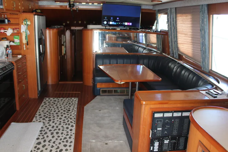Slide: The Image of Luxurious interior of a 1994 Mikelson 64 yacht with dining area and modern amenities. - 11