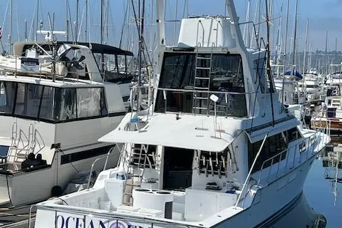 Slide: The Image of 1994 Mikelson 64 yacht docked in a marina, surrounded by other boats. - 33