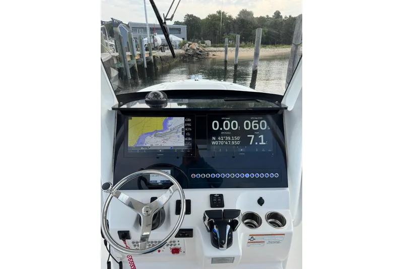 Slide: The Image of 2022 Edgewater 262CC boat dashboard with navigation display and steering wheel. - 10