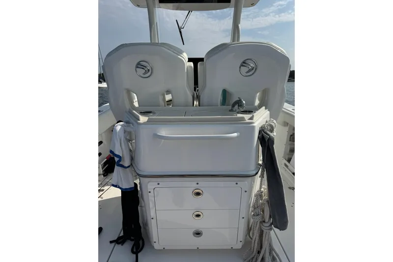 Slide: The Image of 2022 Edgewater 262CC boat interior with dual seats and storage drawers. - 19