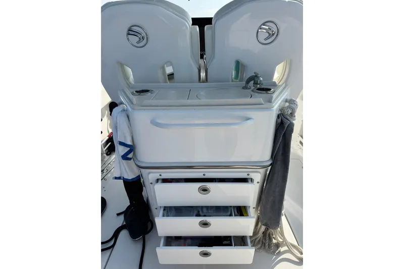 Slide: The Image of 2022 Edgewater 262CC boat console with sink, storage drawers, and accessories. - 20