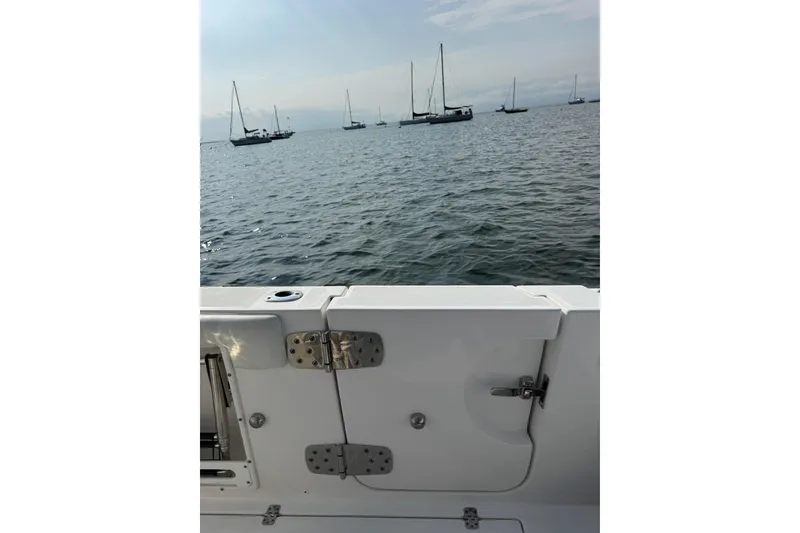 Slide: The Image of Edgewater 262CC boat view with ocean and anchored sailboats in the background. - 26