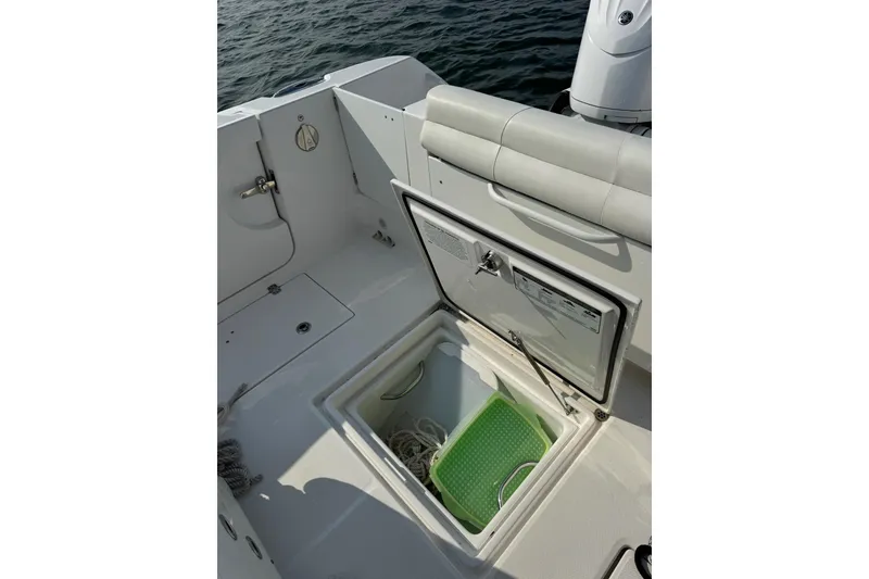 Slide: The Image of Edgewater 262CC 2022 boat interior with open storage compartment and seating. - 35