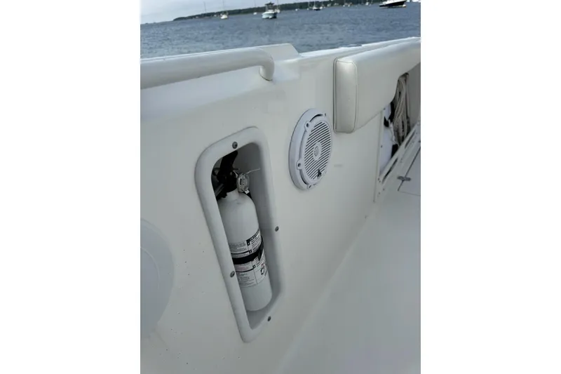 Slide: The Image of 2022 Edgewater 262CC boat interior with fire extinguisher and speaker on deck. - 37