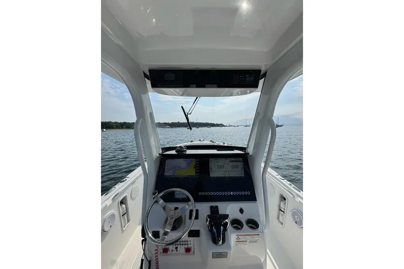 Slide: The Image of Interior view of 2022 Edgewater 262CC boat cockpit with navigation controls. - 9