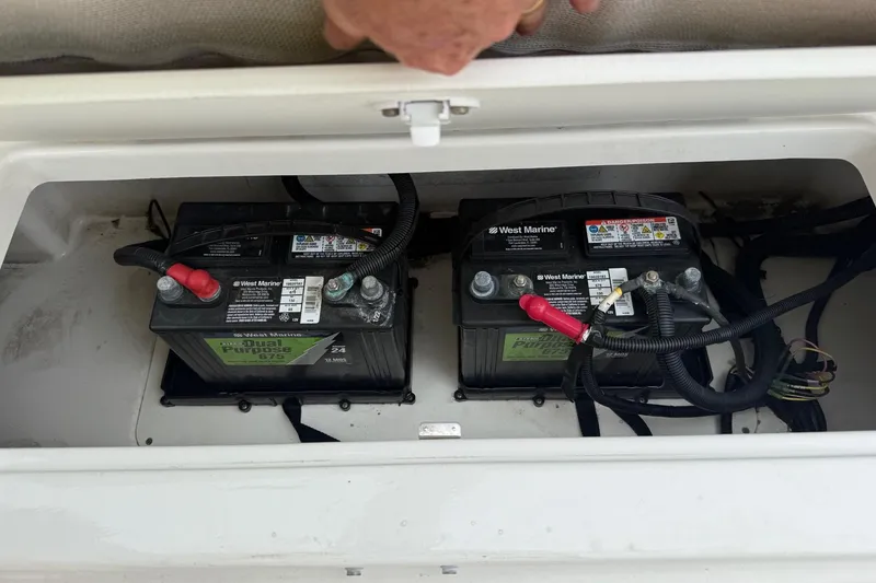 Slide: The Image of Dual marine batteries in a 2022 Bayliner Trophy T22CX boat compartment. - 10