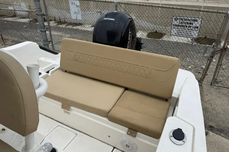 Slide: The Image of 2022 Bayliner Trophy T22CX boat with beige seating and Mercury outboard motor. - 12