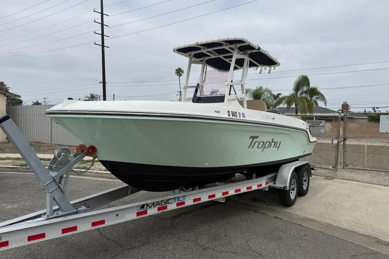 Slide: The Image of 2022 Bayliner Trophy T22CX boat on trailer, parked outdoors. - 14