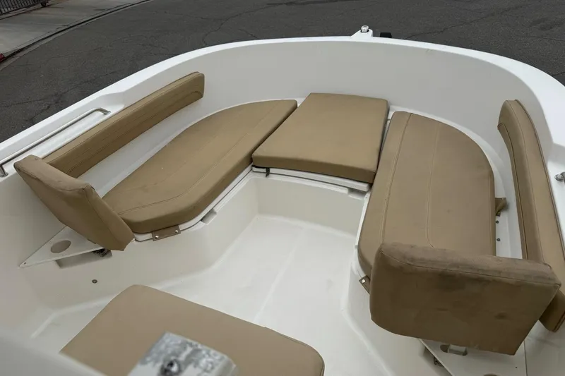 Slide: The Image of 2022 Bayliner Trophy T22CX boat interior with beige cushioned seating. - 15