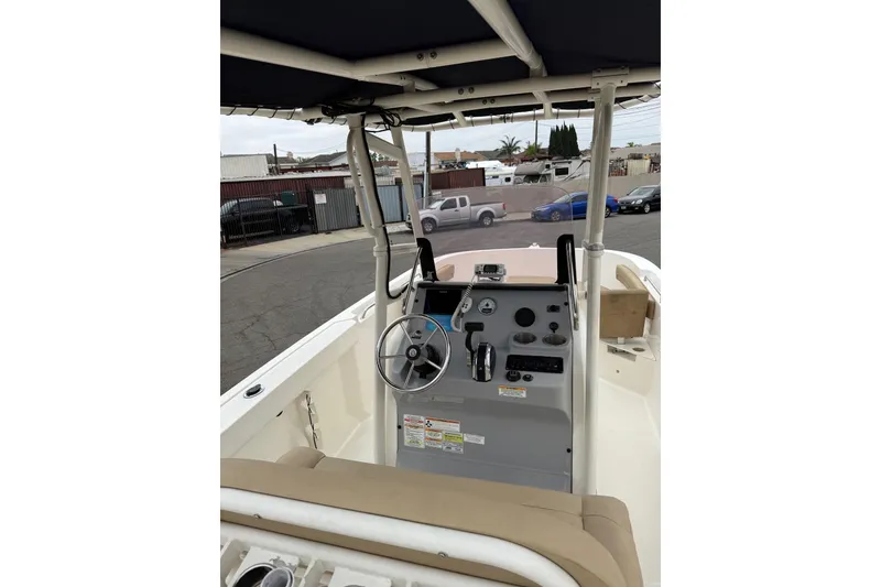 Slide: The Image of 2022 Bayliner Trophy T22CX boat console with steering wheel and controls. - 3