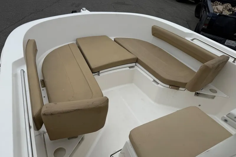 Slide: The Image of 2022 Bayliner Trophy T22CX boat interior with beige cushioned seating. - 7