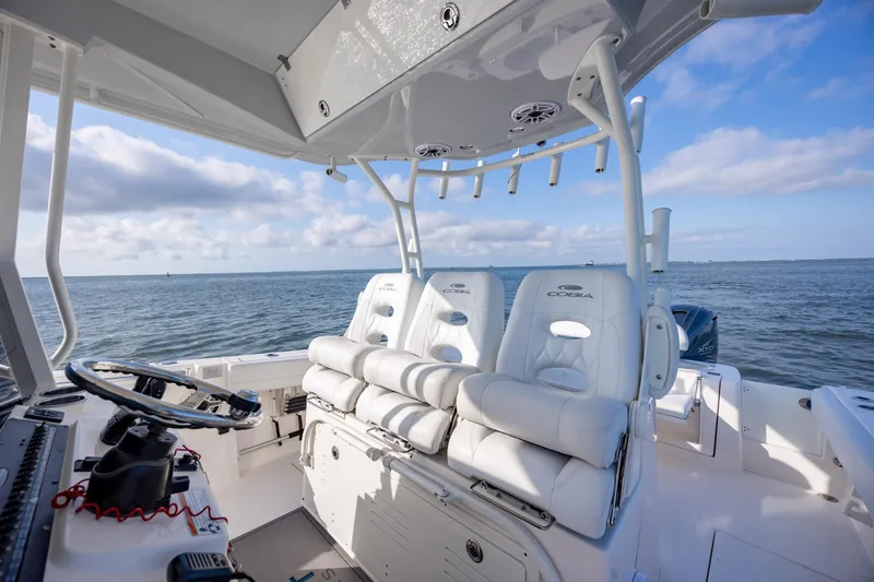 Slide: The Image of 2020 Cobia 350 Center Console boat interior with white seating, ocean view. - 14