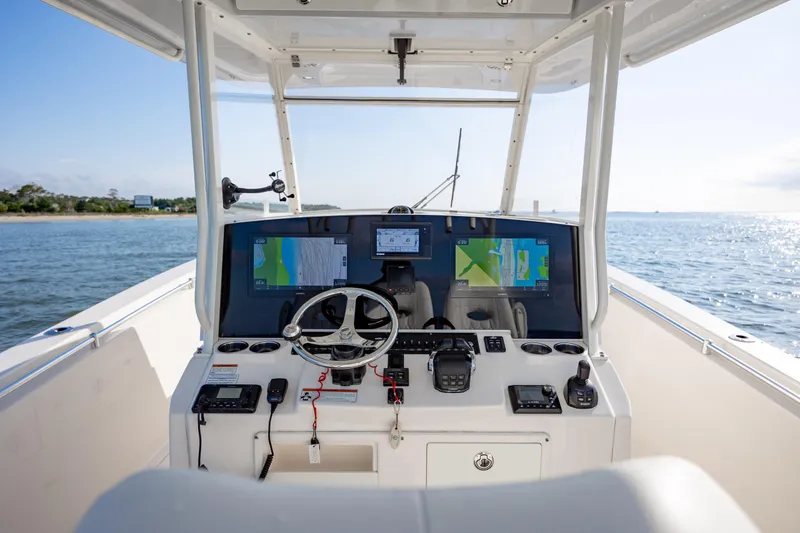 Slide: The Image of 2020 Cobia 350 Center Console boat dashboard with navigation screens on open water. - 15