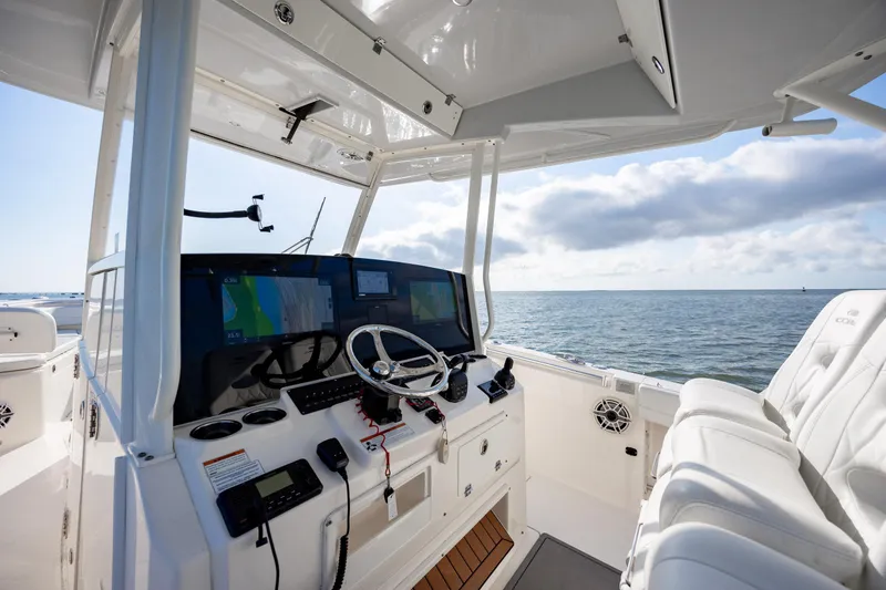Slide: The Image of 2020 Cobia 350 Center Console boat interior with navigation screens and ocean view. - 17