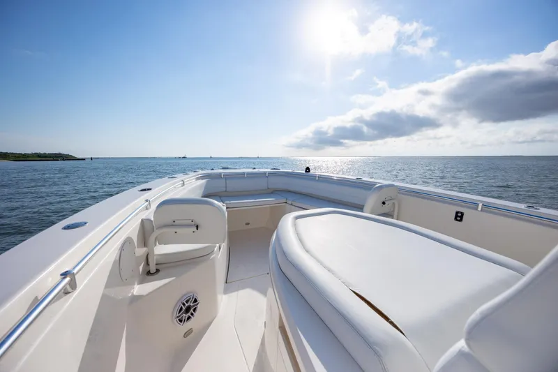 Slide: The Image of 2020 Cobia 350 Center Console boat on open water under clear blue sky. - 18