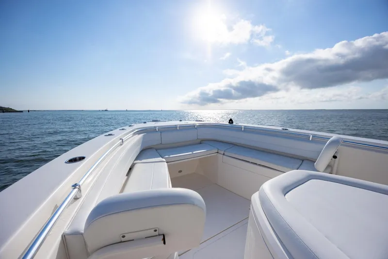 Slide: The Image of 2020 Cobia 350 Center Console boat on calm ocean under clear sky. - 19